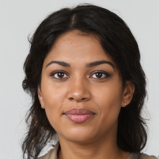 Joyful black young-adult female with medium  brown hair and brown eyes