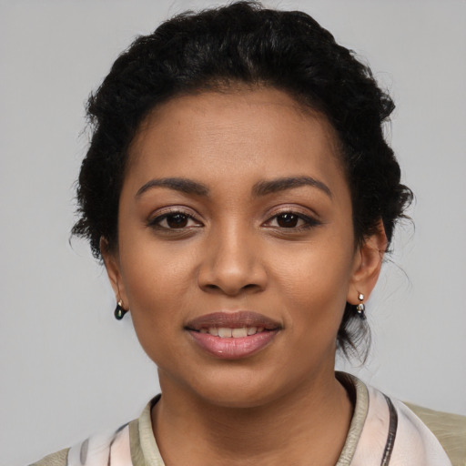 Joyful latino young-adult female with short  black hair and brown eyes