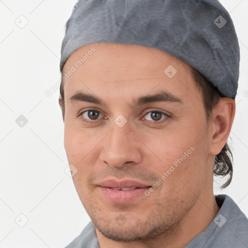 Joyful white young-adult male with short  brown hair and brown eyes