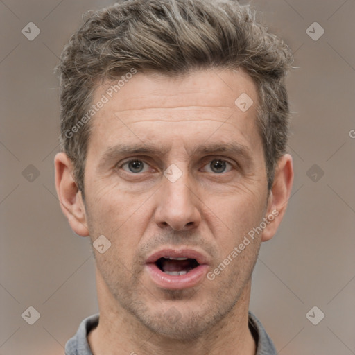 Joyful white adult male with short  brown hair and grey eyes