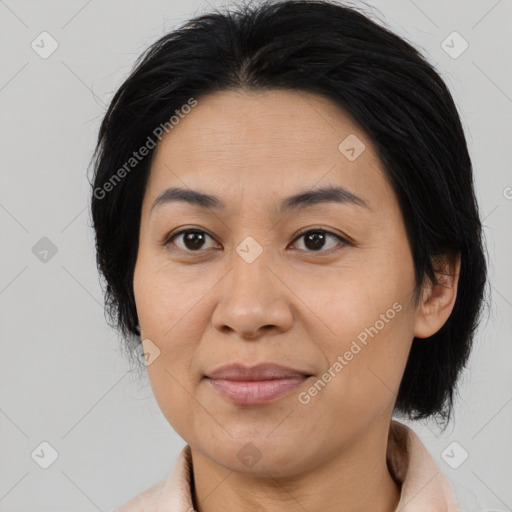 Joyful asian adult female with medium  brown hair and brown eyes