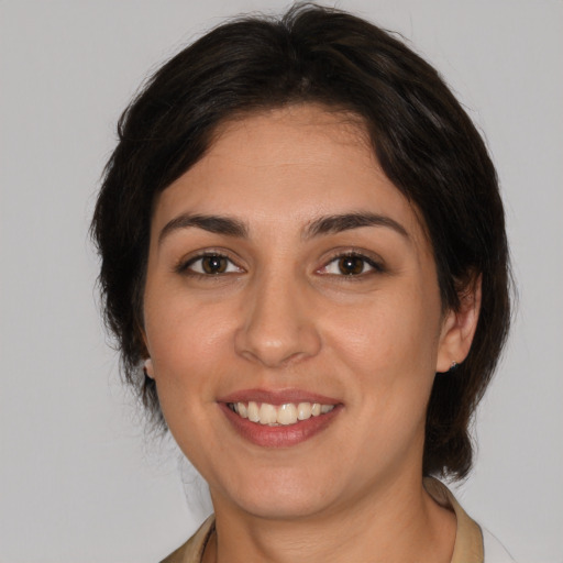 Joyful white young-adult female with medium  brown hair and brown eyes