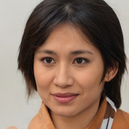 Joyful asian young-adult female with medium  brown hair and brown eyes