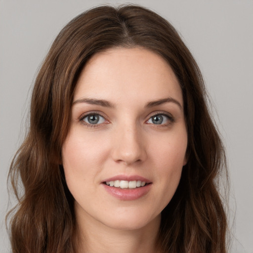 Joyful white young-adult female with long  brown hair and grey eyes