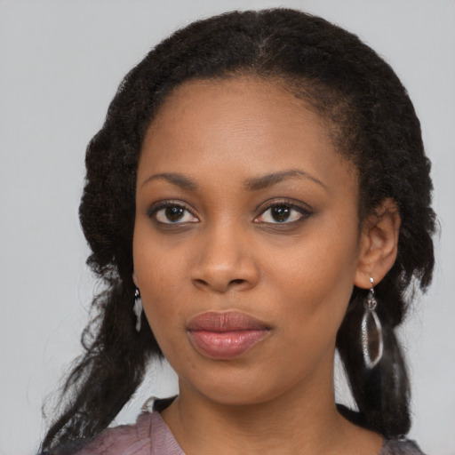 Joyful black young-adult female with medium  black hair and brown eyes