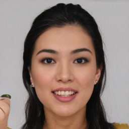 Joyful asian young-adult female with long  brown hair and brown eyes