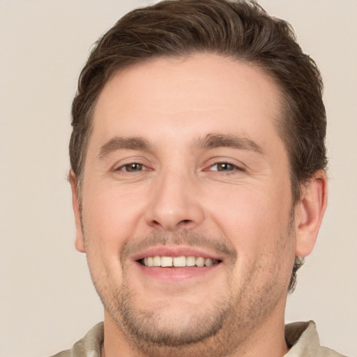 Joyful white adult male with short  brown hair and brown eyes