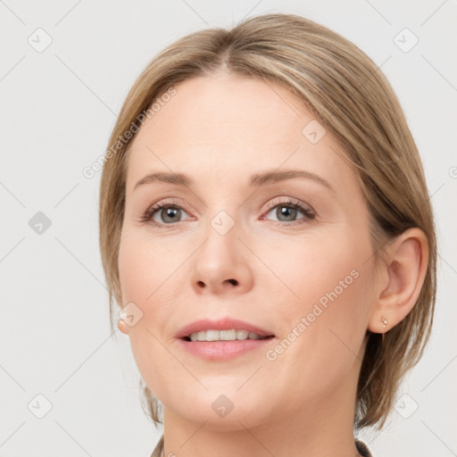 Joyful white young-adult female with medium  brown hair and blue eyes