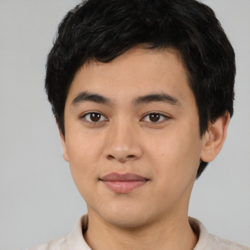 Joyful asian young-adult male with short  brown hair and brown eyes