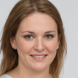 Joyful white young-adult female with medium  brown hair and green eyes