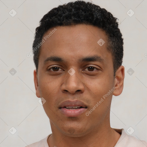 Joyful black young-adult male with short  black hair and brown eyes