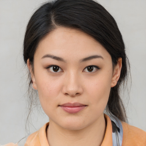 Joyful asian young-adult female with medium  brown hair and brown eyes
