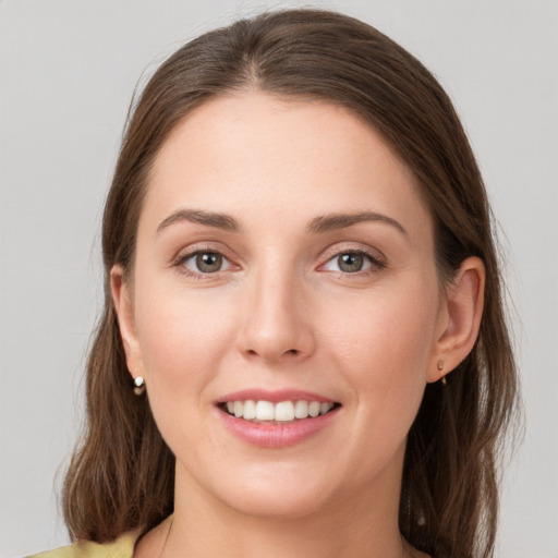 Joyful white young-adult female with medium  brown hair and grey eyes