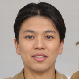 Joyful asian young-adult male with short  brown hair and brown eyes