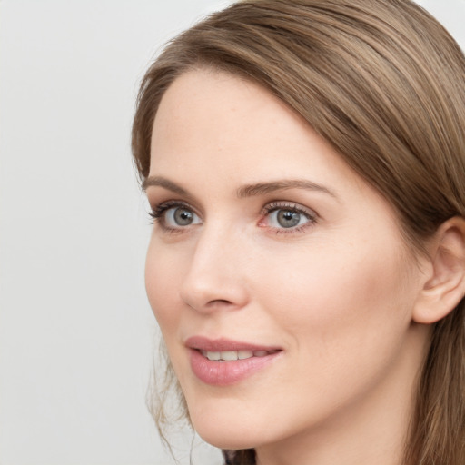 Joyful white young-adult female with long  brown hair and grey eyes