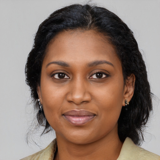 Joyful black young-adult female with medium  brown hair and brown eyes