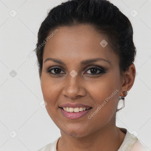 Joyful latino young-adult female with short  brown hair and brown eyes