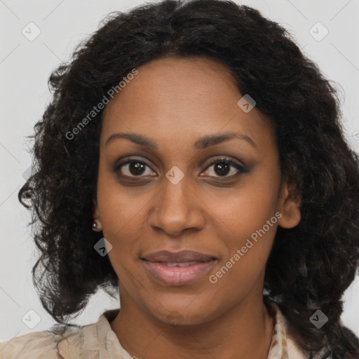 Joyful black young-adult female with long  brown hair and brown eyes