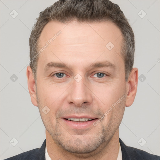 Joyful white adult male with short  brown hair and grey eyes