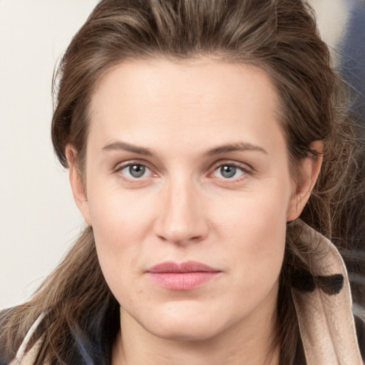 Joyful white young-adult female with long  brown hair and grey eyes