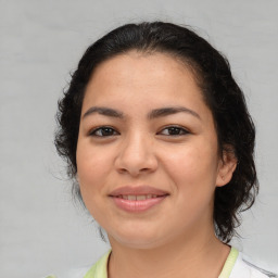 Joyful latino young-adult female with medium  brown hair and brown eyes