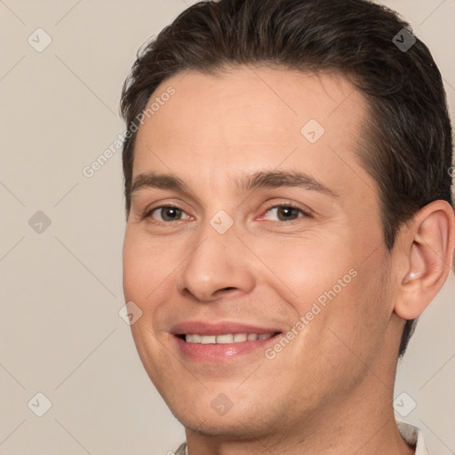 Joyful white adult male with short  brown hair and brown eyes