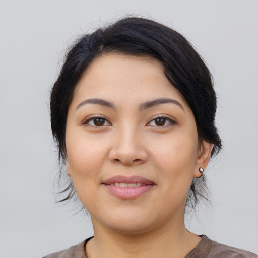 Joyful latino young-adult female with medium  brown hair and brown eyes