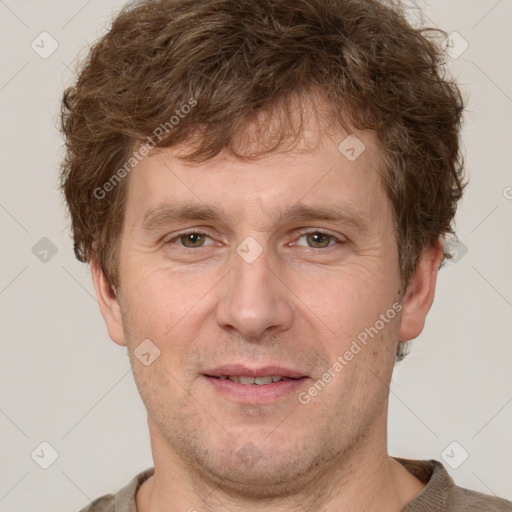 Joyful white adult male with short  brown hair and grey eyes