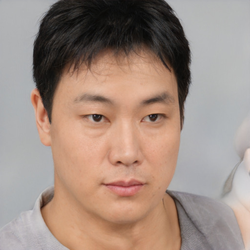 Neutral asian young-adult male with short  brown hair and brown eyes
