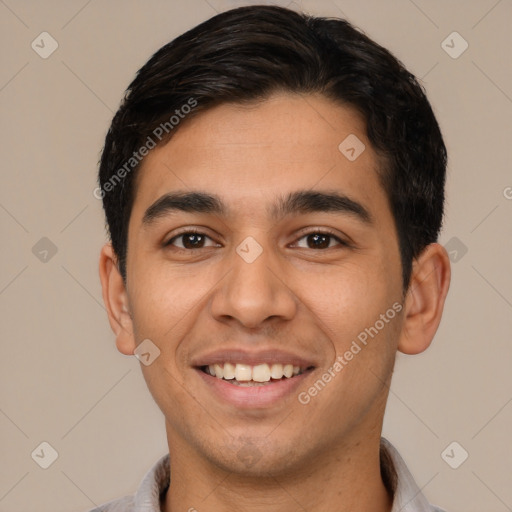 Joyful latino young-adult male with short  brown hair and brown eyes