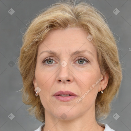 Joyful white adult female with medium  brown hair and blue eyes