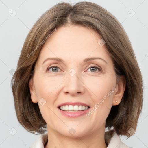 Joyful white adult female with medium  brown hair and grey eyes