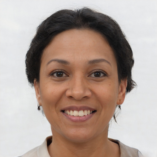 Joyful latino adult female with short  brown hair and brown eyes