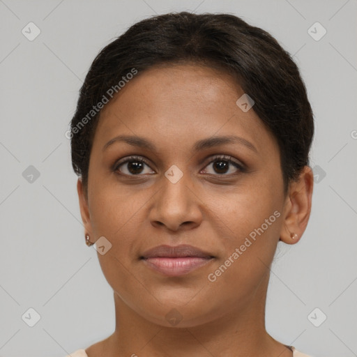 Joyful black young-adult female with short  brown hair and brown eyes