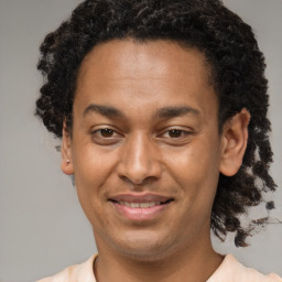 Joyful black young-adult male with short  brown hair and brown eyes