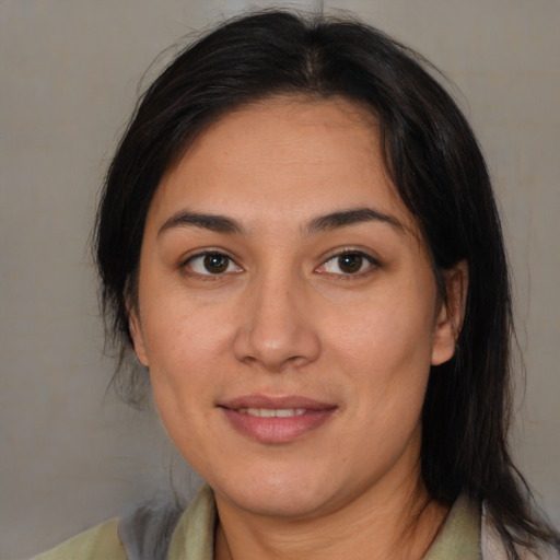 Joyful latino young-adult female with medium  brown hair and brown eyes