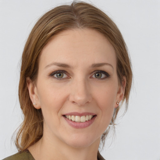 Joyful white young-adult female with medium  brown hair and grey eyes