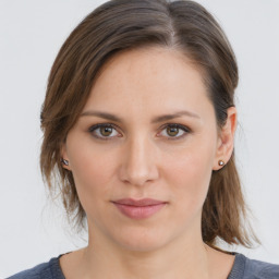 Joyful white young-adult female with medium  brown hair and grey eyes