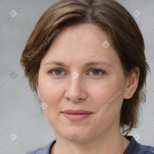 Joyful white adult female with medium  brown hair and grey eyes