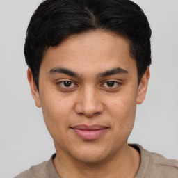 Joyful latino young-adult male with short  brown hair and brown eyes