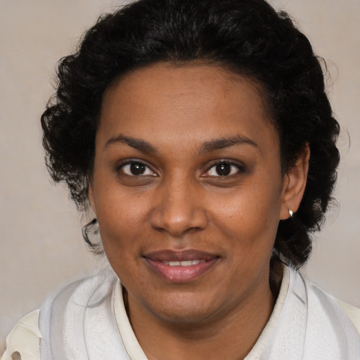 Joyful black young-adult female with medium  brown hair and brown eyes