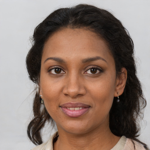 Joyful black young-adult female with medium  brown hair and brown eyes