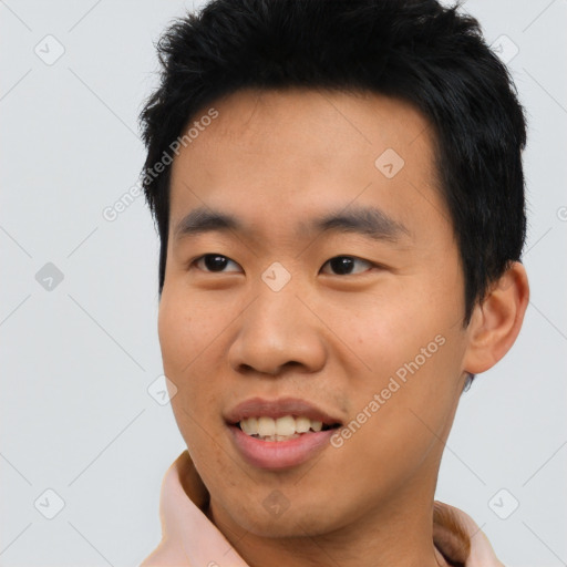 Joyful asian young-adult male with short  black hair and brown eyes