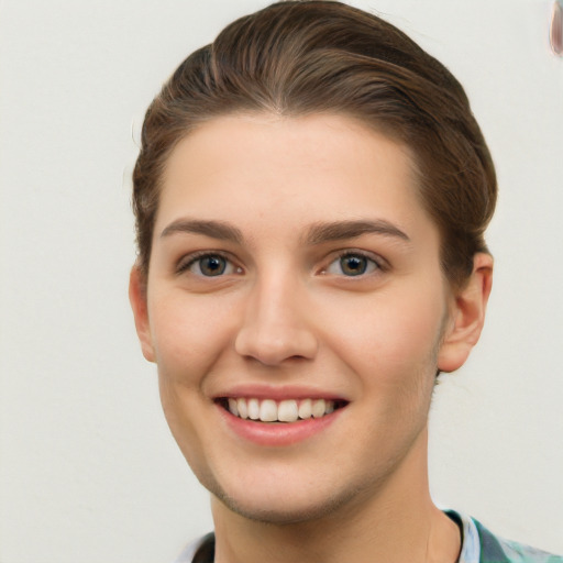 Joyful white young-adult female with short  brown hair and grey eyes