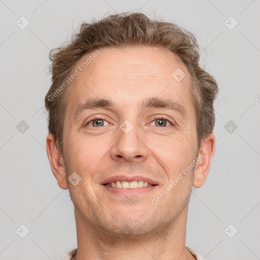 Joyful white adult male with short  brown hair and grey eyes