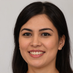 Joyful white young-adult female with long  brown hair and brown eyes