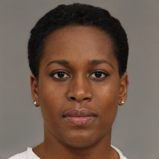 Joyful black young-adult female with short  brown hair and brown eyes