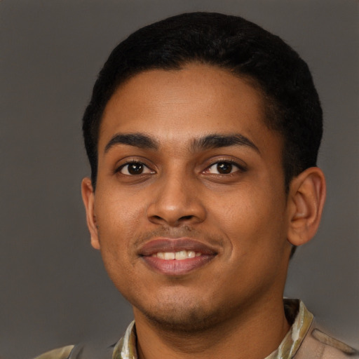 Joyful black young-adult male with short  brown hair and brown eyes