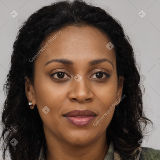 Joyful black young-adult female with long  brown hair and brown eyes