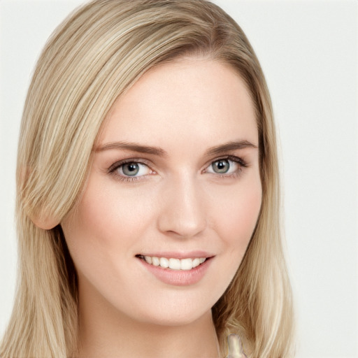 Joyful white young-adult female with long  brown hair and blue eyes